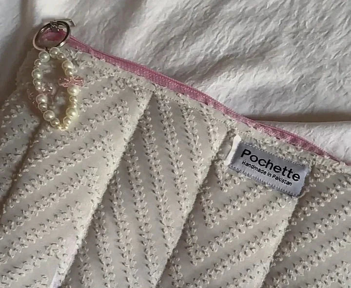 Handmade cotton beauty case with pearl keychain, pink trim, and chevron texture detail