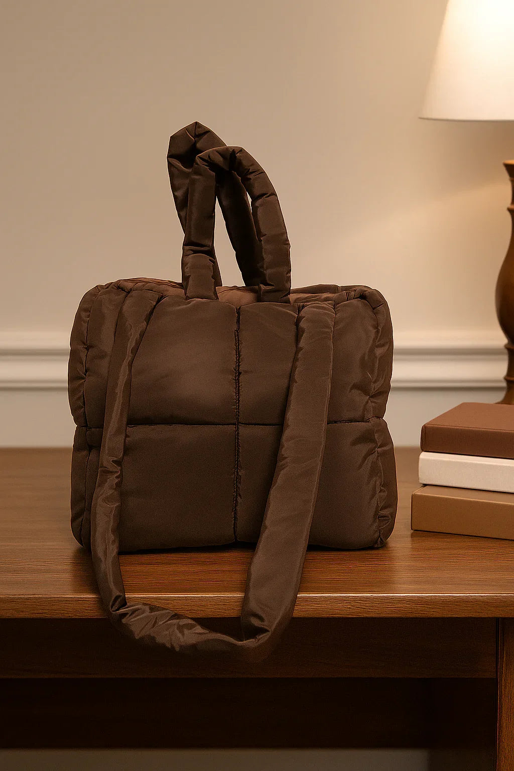Brown quilted cotton beauty case with handles, placed on a wooden desk indoors